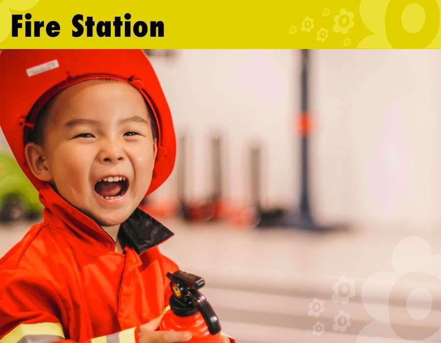 Indoor role play area themed as a fire station where children can use their imagination