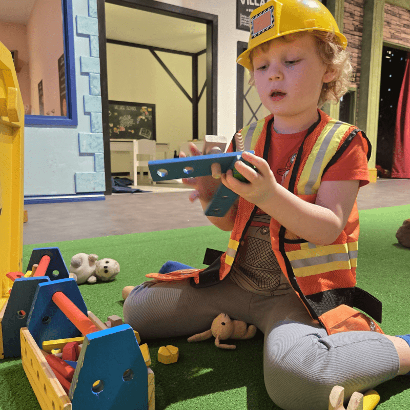 No soft play ball pits here! Children explore our nine role play areas at Discovery Village