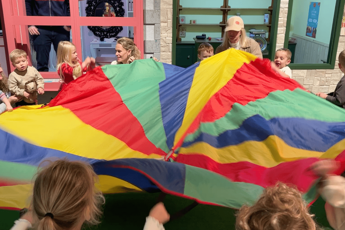 Children help to set up the Family Festival this summer holidays at Discovery Village with parachute games