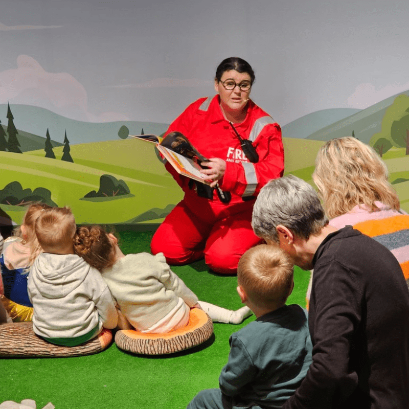 Parents with their little treasures enjoying story time at Discovery Village Role Play Cafe